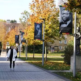 student walking across campus in autumn