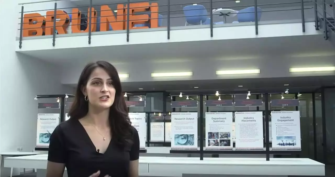 female student in front of a Brunel sign(1)