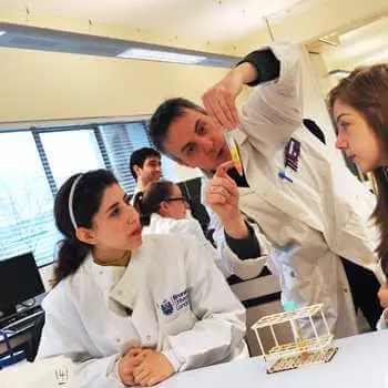 male lecturer explaining an experiment to two students in a science laboratory at Brunel University London
