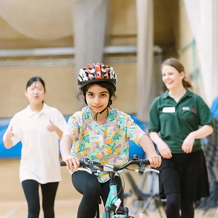 a-child-cycling-in-the-sports-hall