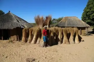 African man in front house