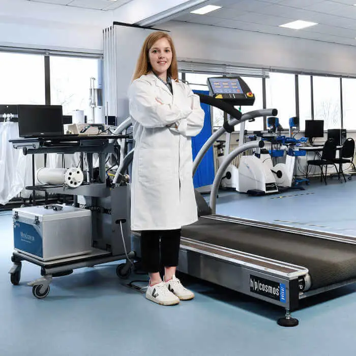 woman standing infront of equipment in sports lab