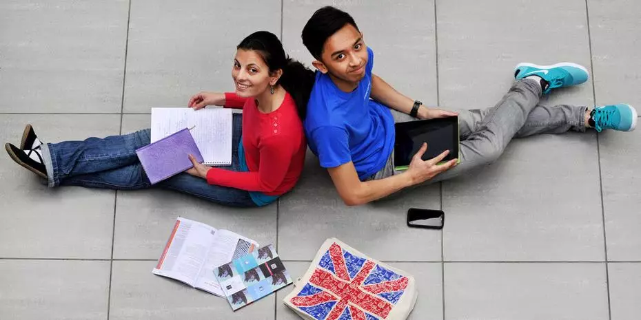 two international students in the UK checking their notes