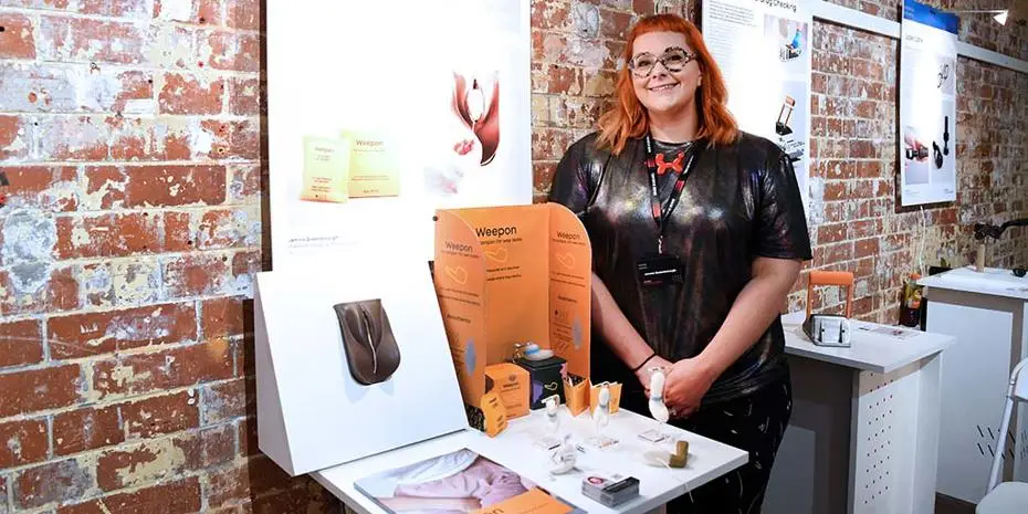 Industrial Design & Technology BA student Jemma Queenborough standing by her final year project Weepon,.