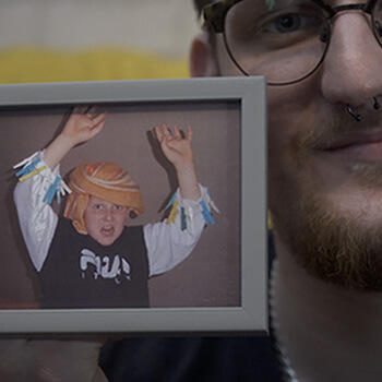 Man holding photo of child Image