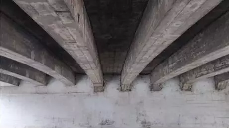 View of longitudinal reinforced concrete beams on underside of bridge