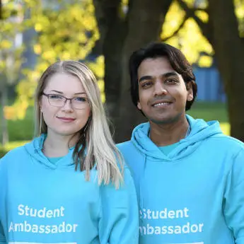 two student ambassadors smiling into the camera