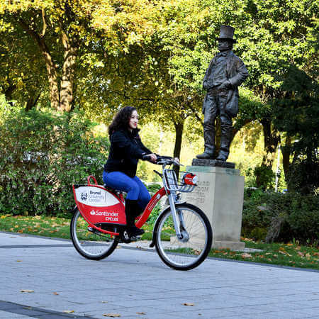 female students cycling through campus