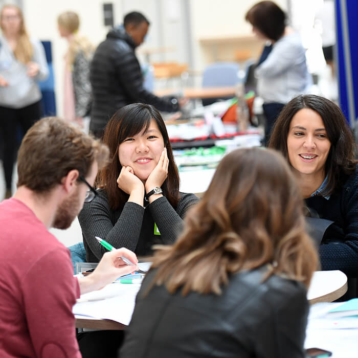 four students studying together around a table