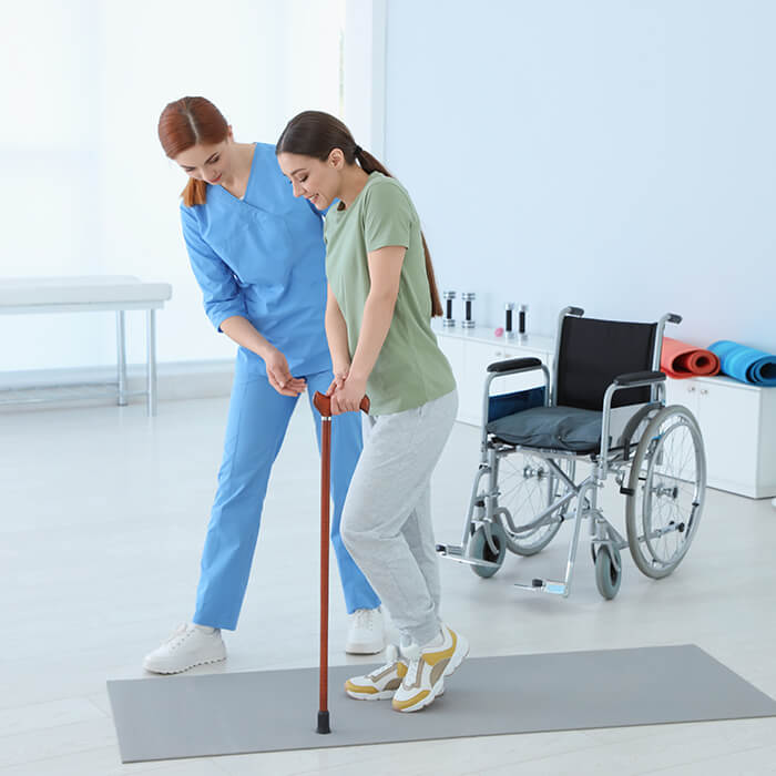 physiotherapist working with female patient in rehabilitation center