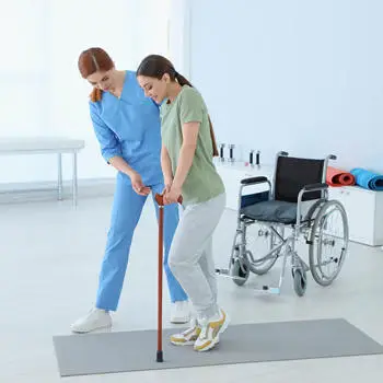 physiotherapist working with female patient in rehabilitation center