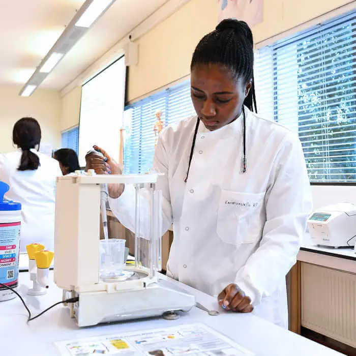 female biomedical sciences student carrying out an experiment in the lab