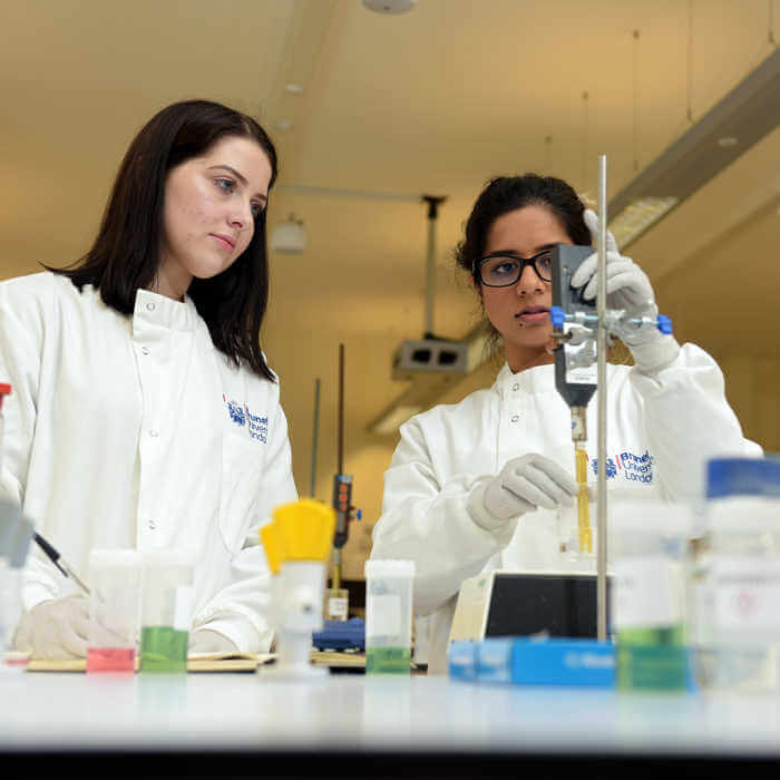 two students performing experience in biomedical sciences lab 2