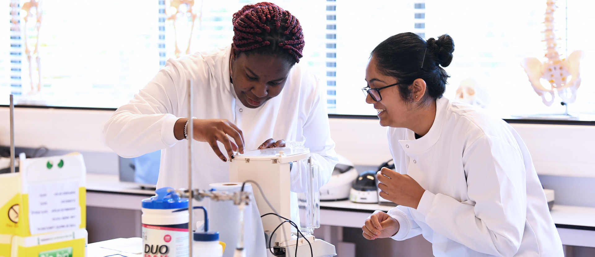 two female  biomedical sciences students in lab