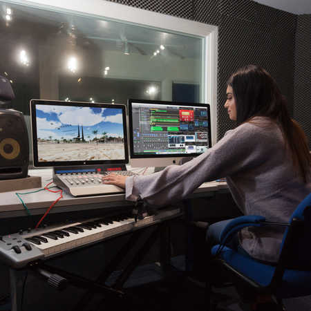 digital media student testing equipment in sound studio