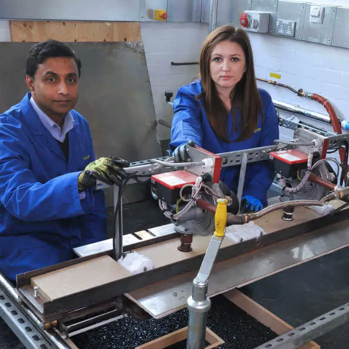 two researchers in the civil engineering research centre with a pothole repair machine