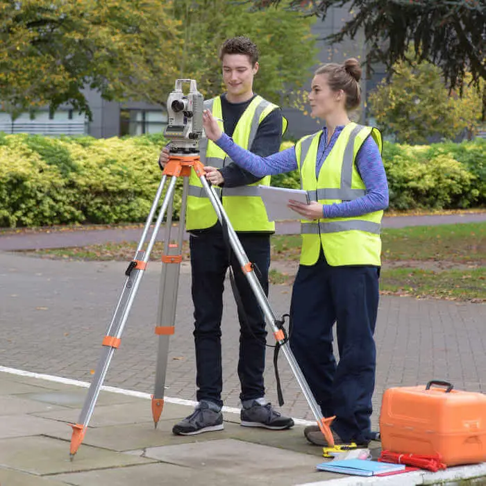 two students on civil engineering surveying practical