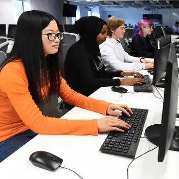 students working on desktops in a classroom