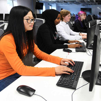 students working on desktops in a classroom
