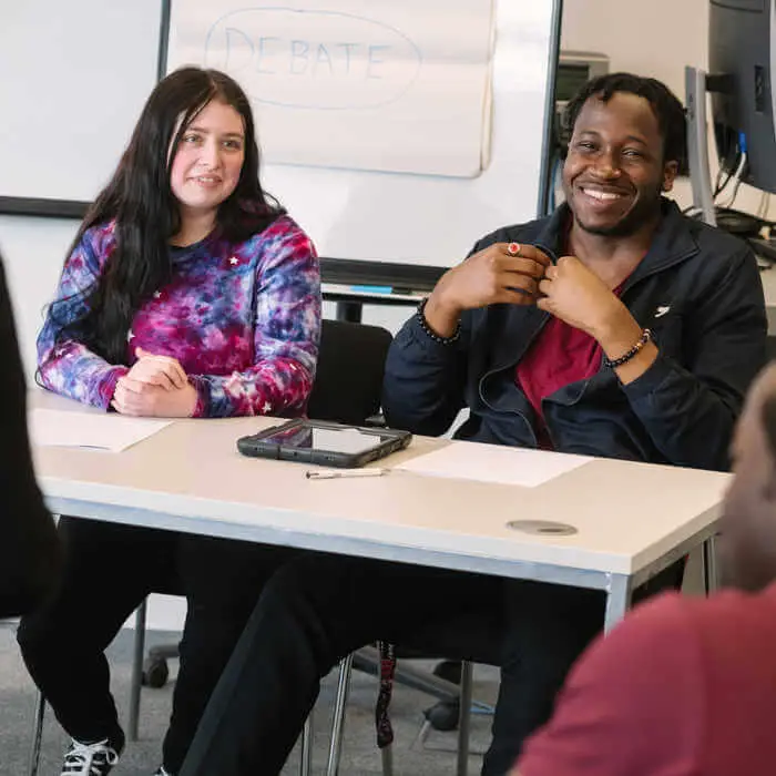 male and female student sitting at a desk