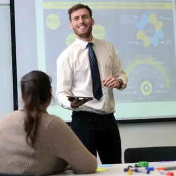 A newly graduated Economics and Finance alumni student enjoying the benefits of the Economics and Finance degree exemptions and accreeditations in his new job