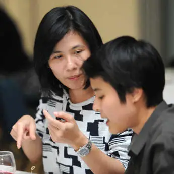 A staff member talking to an Economics and Finance student at the graduate school