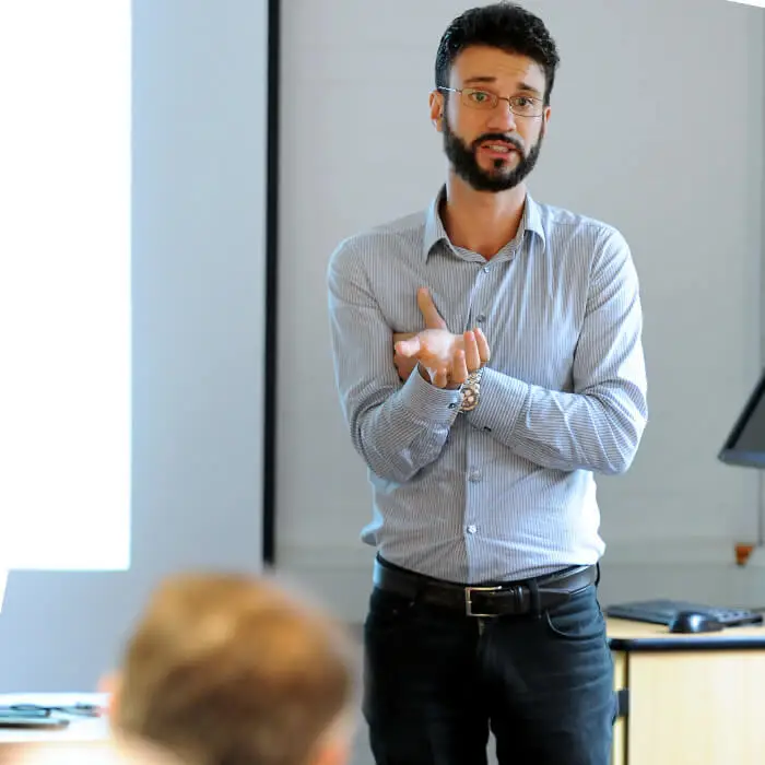 An Economics academic lecturing in a classroom