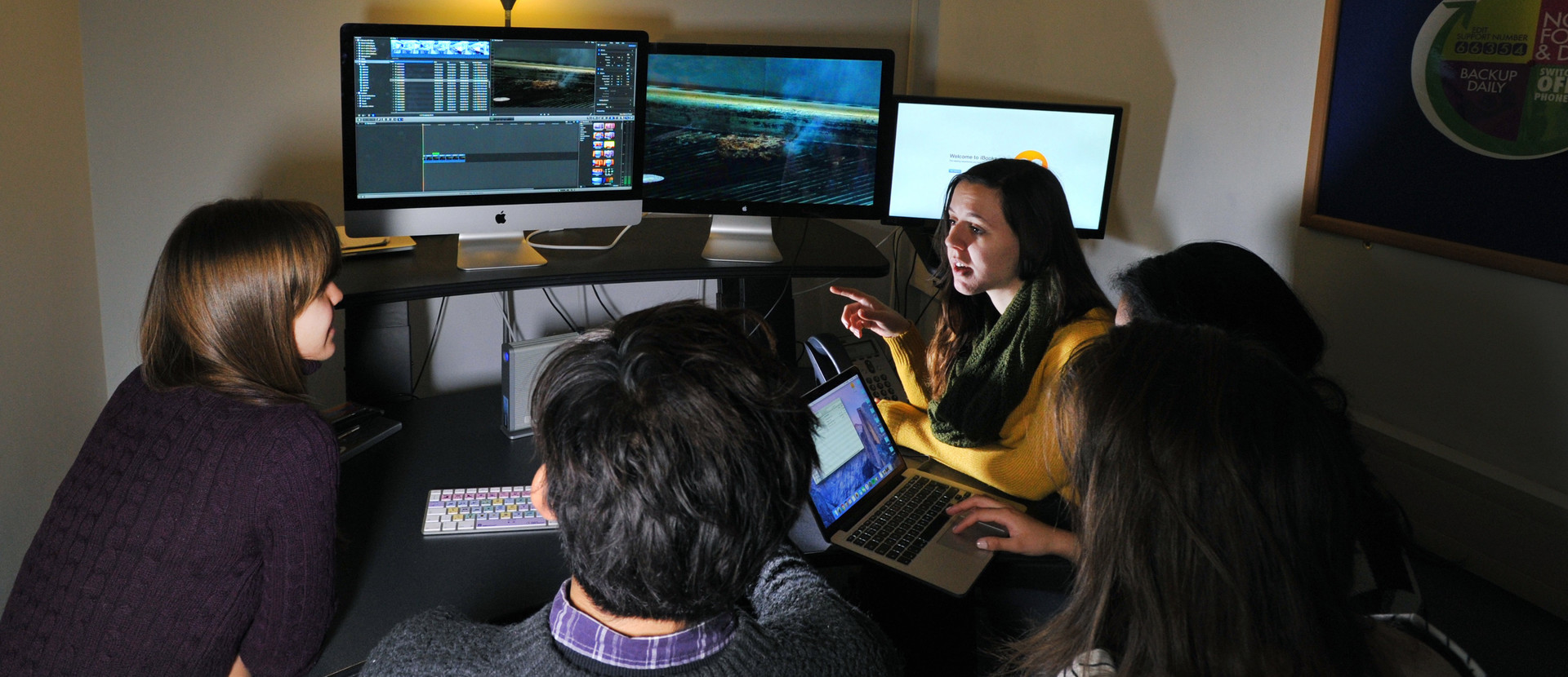 Film students using film production computers in a classroom