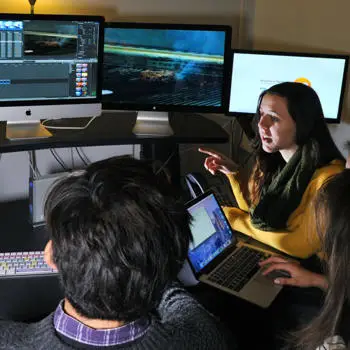 Film students using film production computers in a classroom