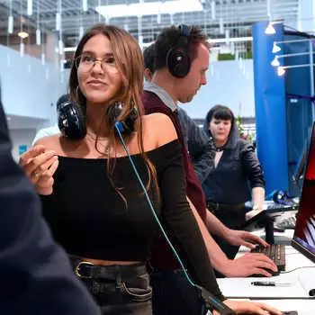 female-games-design-student-in-the-foreground-wearing headphones