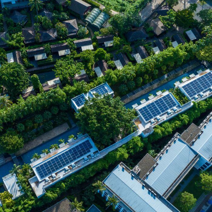 An aerial view of buildings with solar panels.