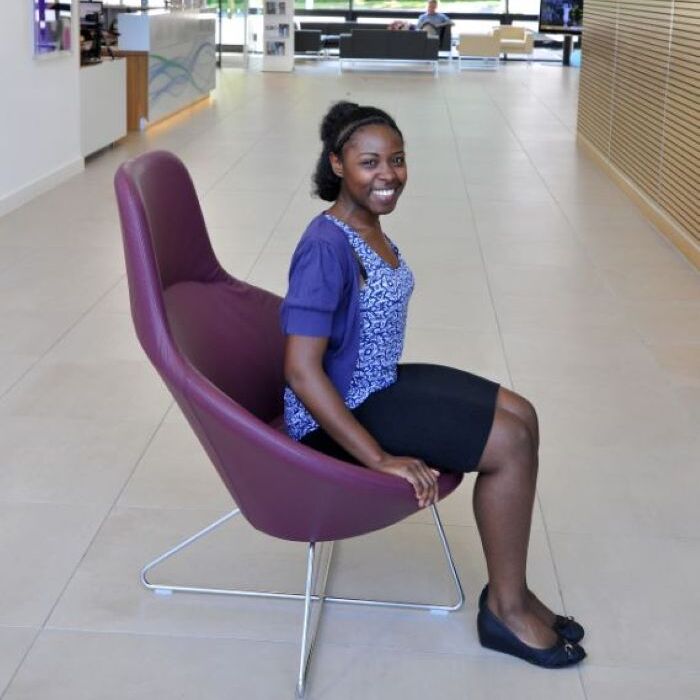 female student sitting on purple chair in office