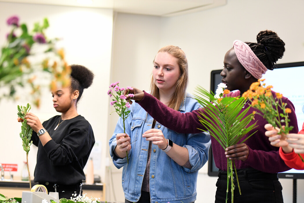 image of two students picking flowers