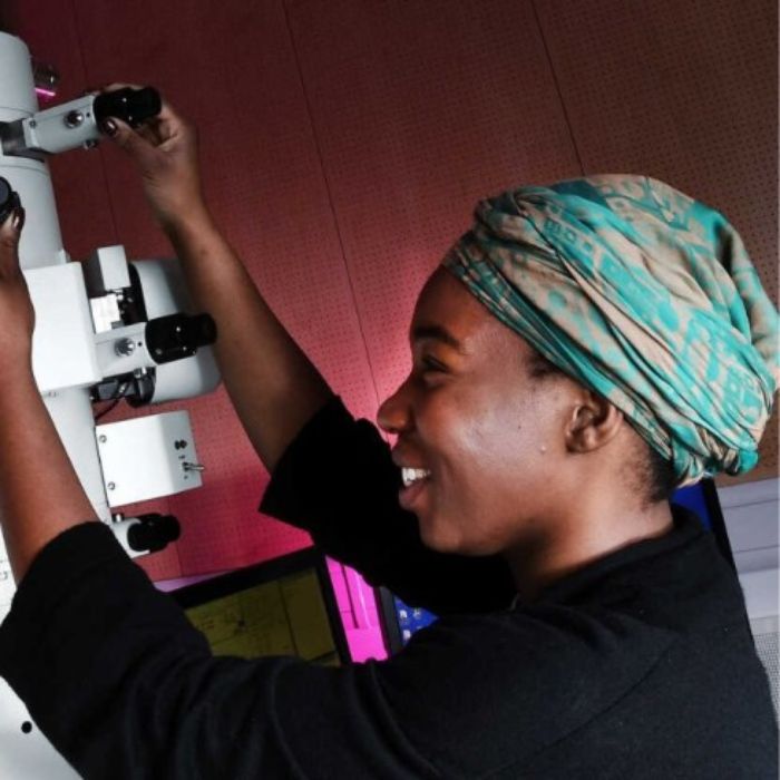 Person adjusting research equipment