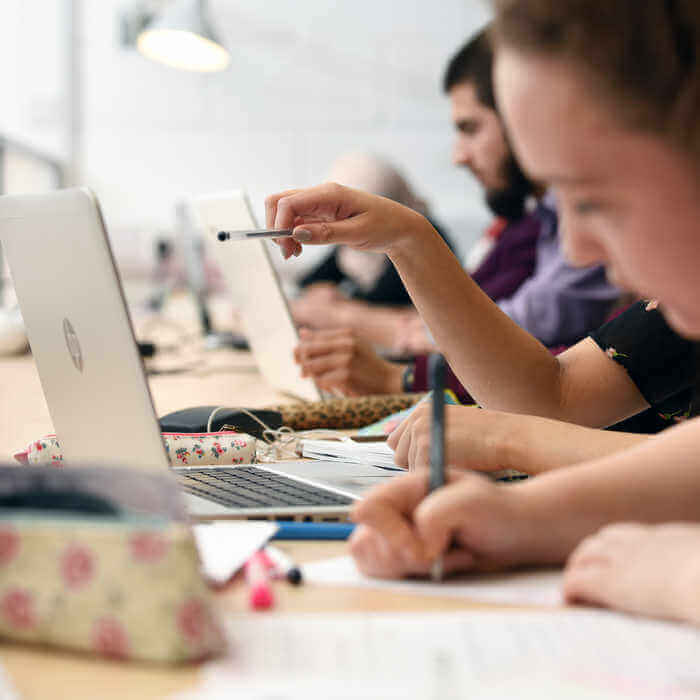 group of students in front of laptops
