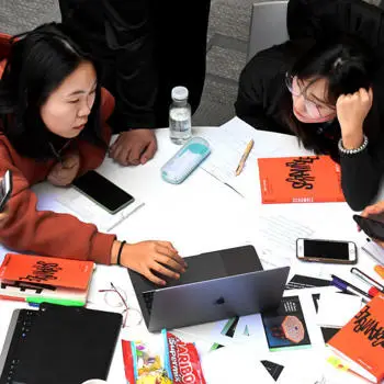 group of students sitting round a table working