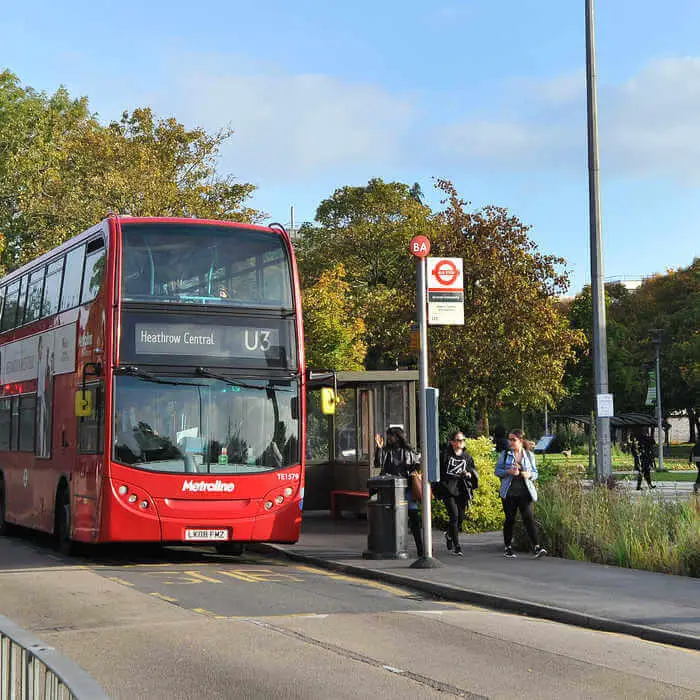 red bus outside brunel campus