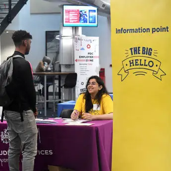 Current student welcoming new student at Big hello check in point