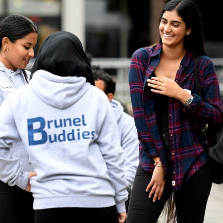 New student chatting to two buddies