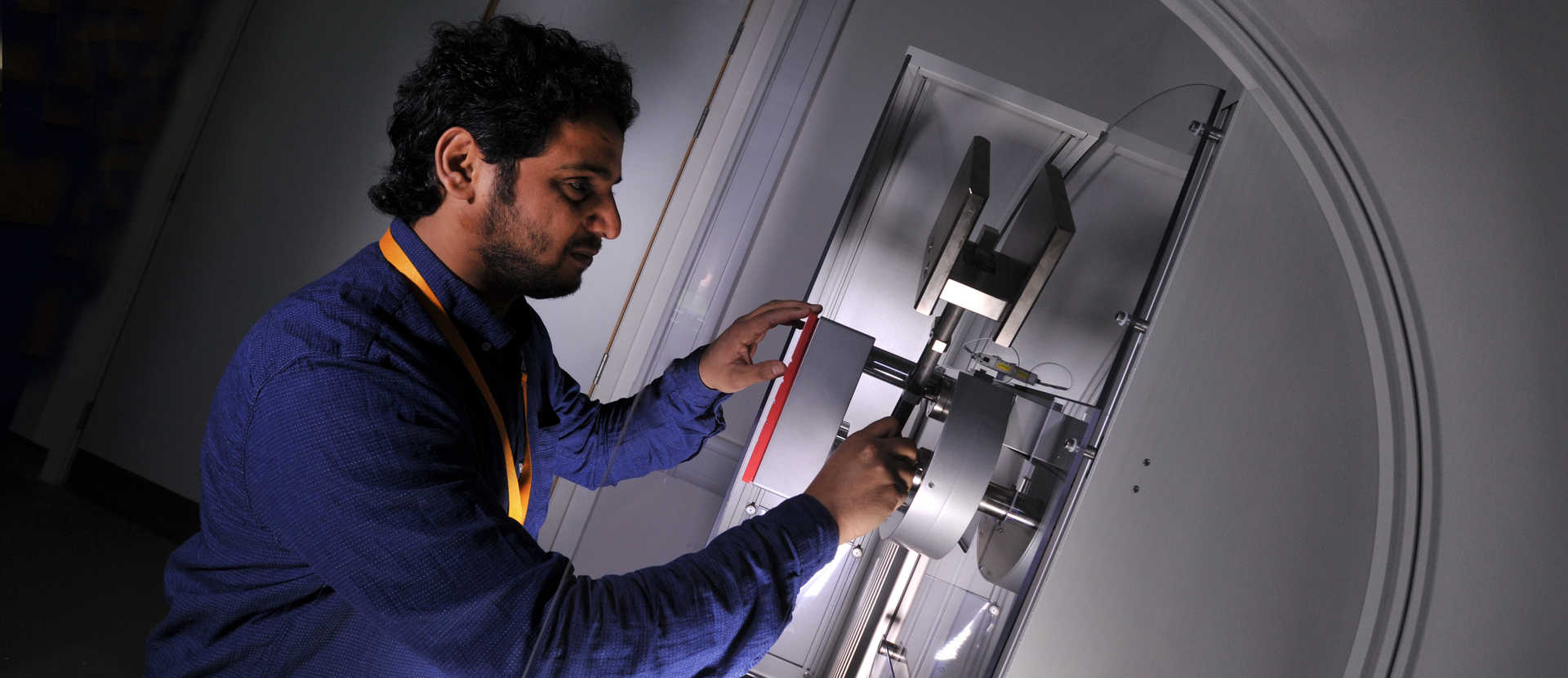 PhD student in structural engineering lab operating machinery