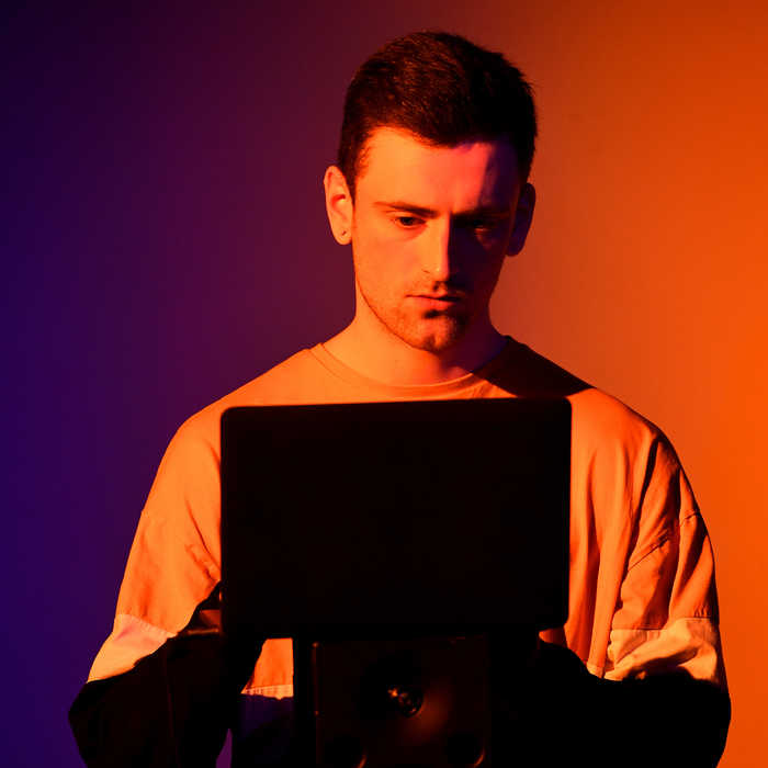 music work placement imageboxmale student using a tablet which is in shadow on front of him