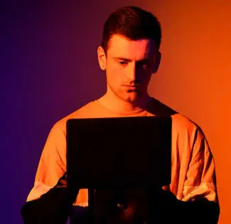 music work placement imageboxmale student using a tablet which is in shadow on front of him