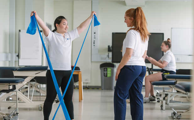 physiotherapy and occupational therapy students working out in the skills lab