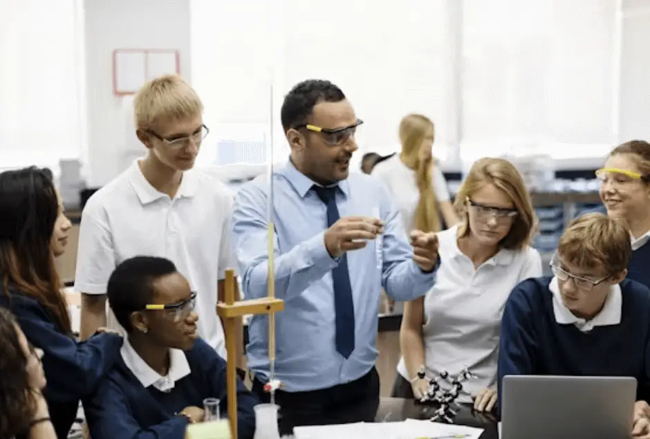 A-teacher-demonstrates-a-science-experiment-to-a-group-of-attentive-students-Banner