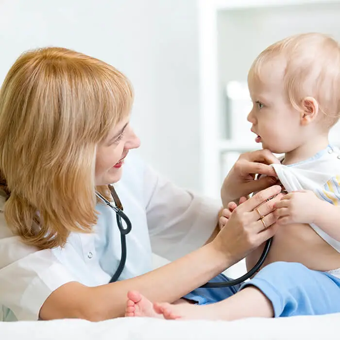 healthcare professional examining a child