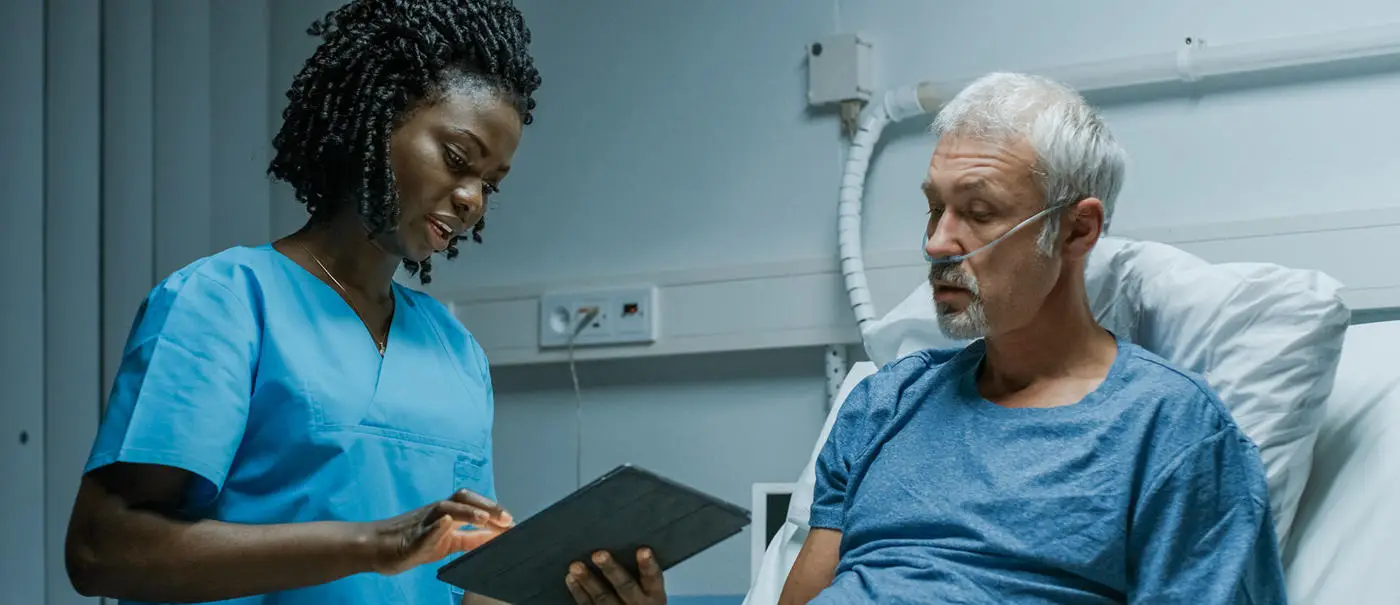 female nurse checking patient files while chatting with the patient