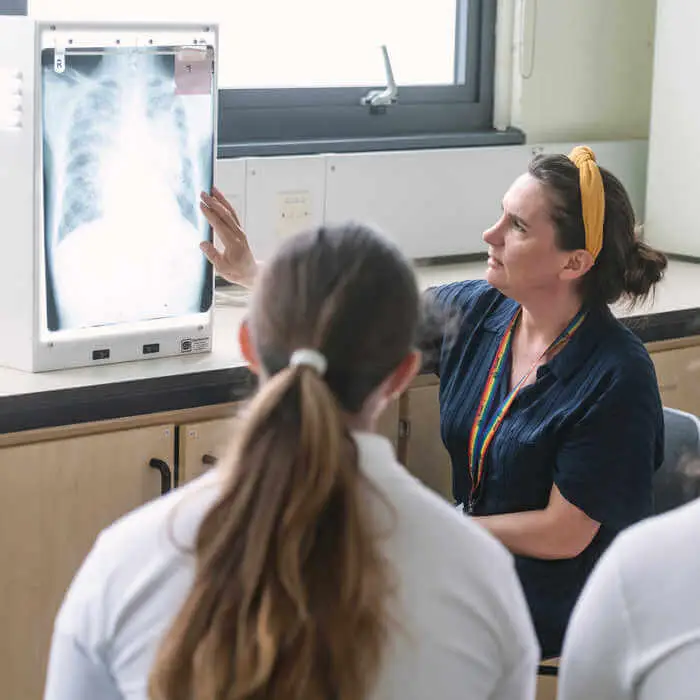 student and academic looking at a chest xray