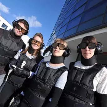 four-physiotherapy-students-in-ageing-simulation-suits-in-front-of-a-building-at-brunel-university-london