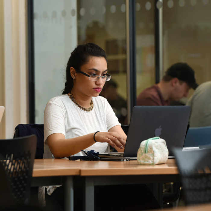 female student working on laptop