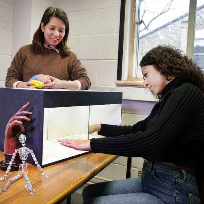 psychology student carrying out a phantom limb experiment